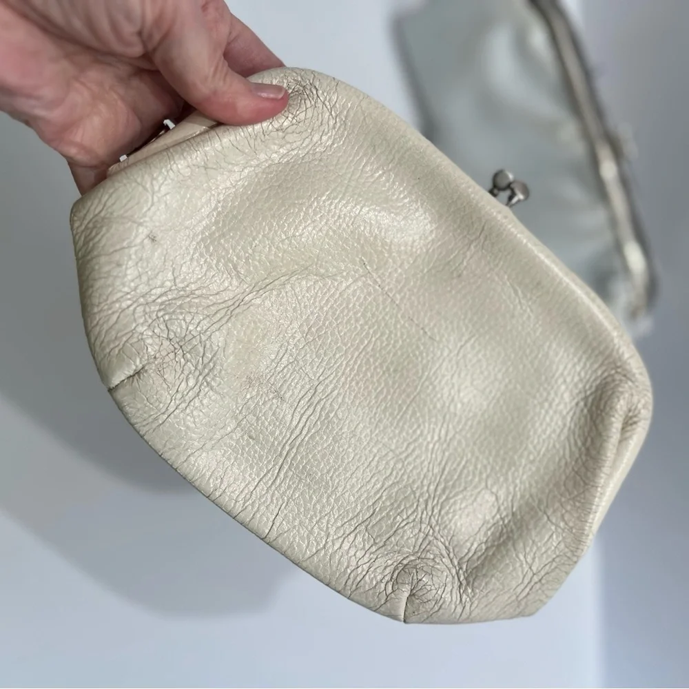 Vintage pair of white leather clutches, one is 70’s with great blk/white lining